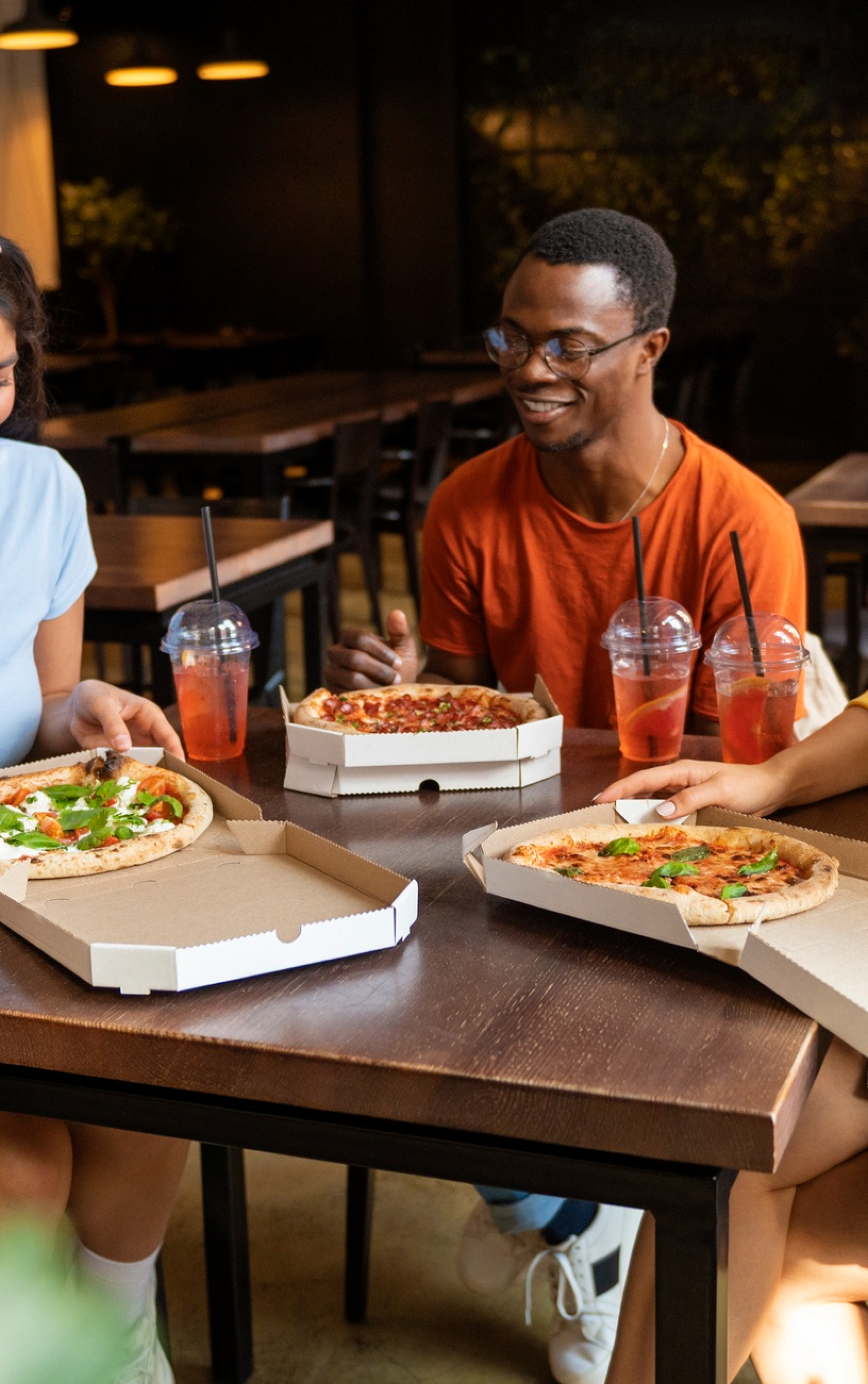 Friends sharing pizza at a table